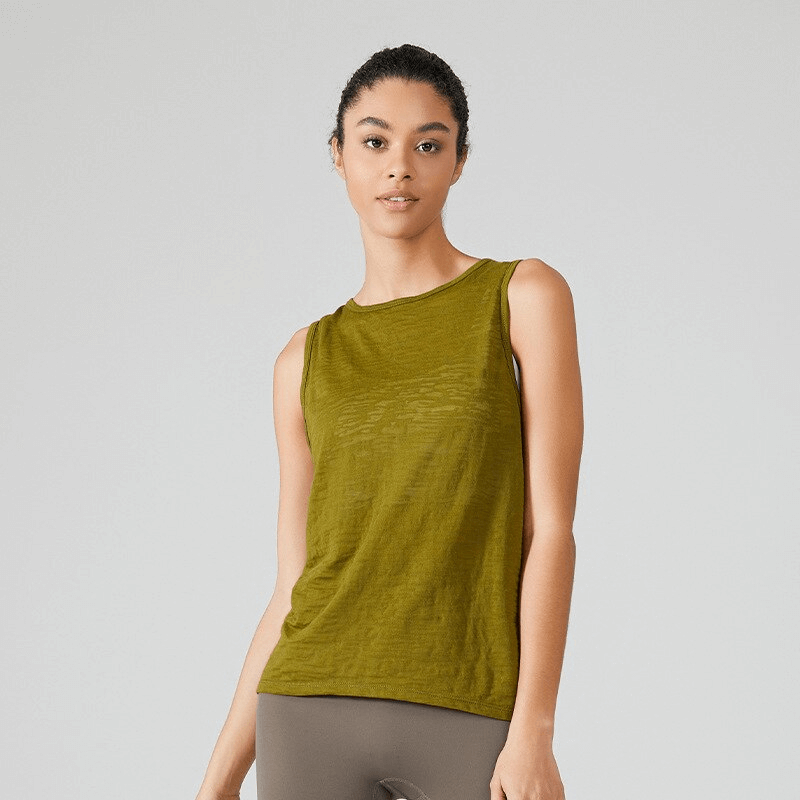 Woman wearing green sporty lightweight tank top with cut on back, perfect for Pilates, running, or cycling.